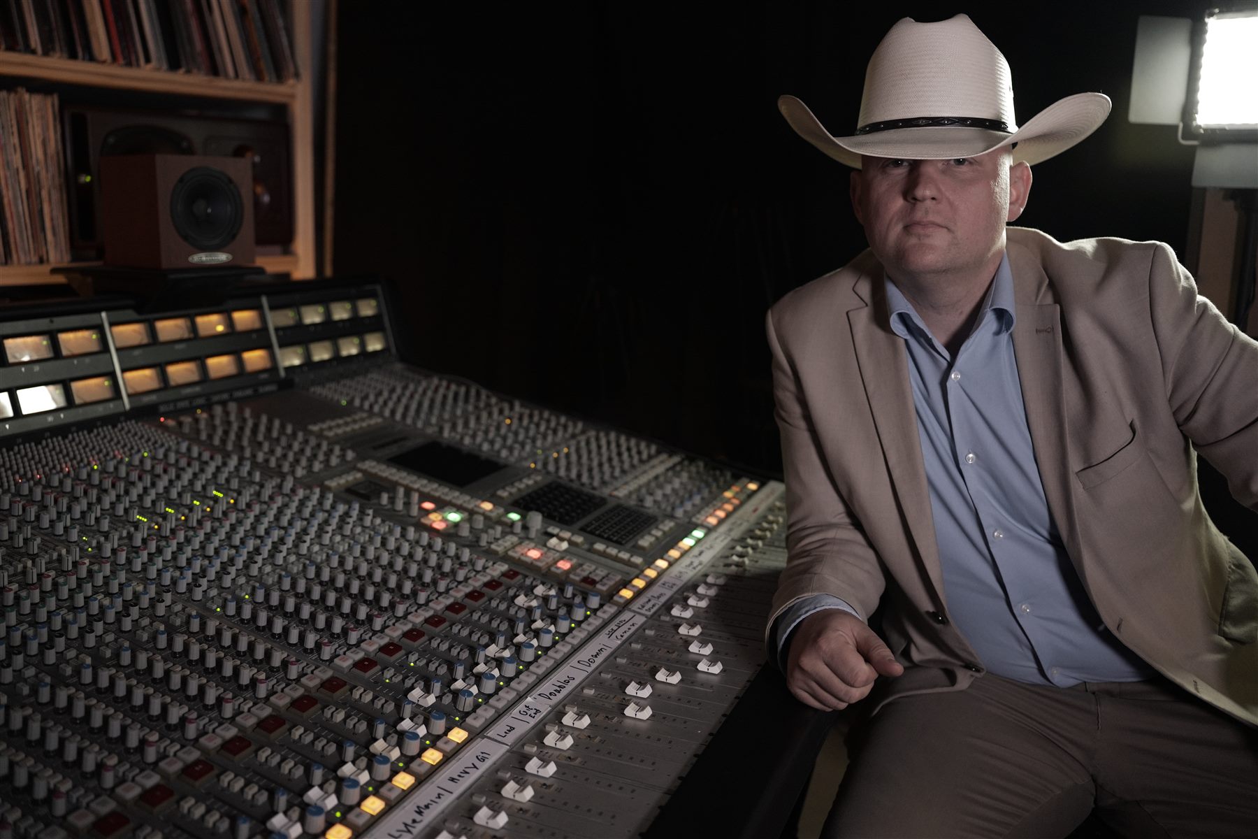 Engineer seated beside the mixing console