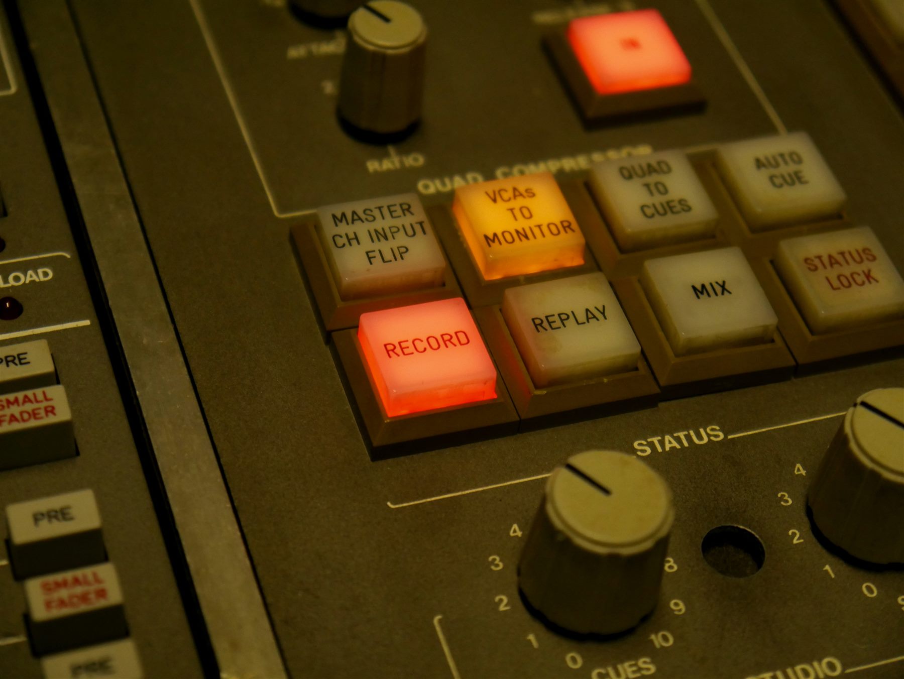 Close-up of a lit RECORD button on the console